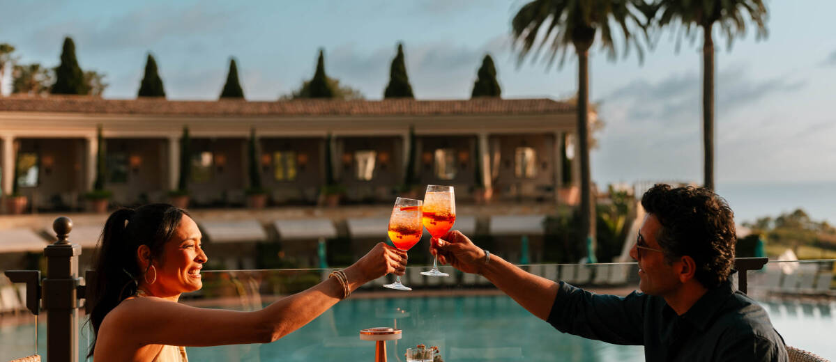 couple cheers at coliseum pool restaurant