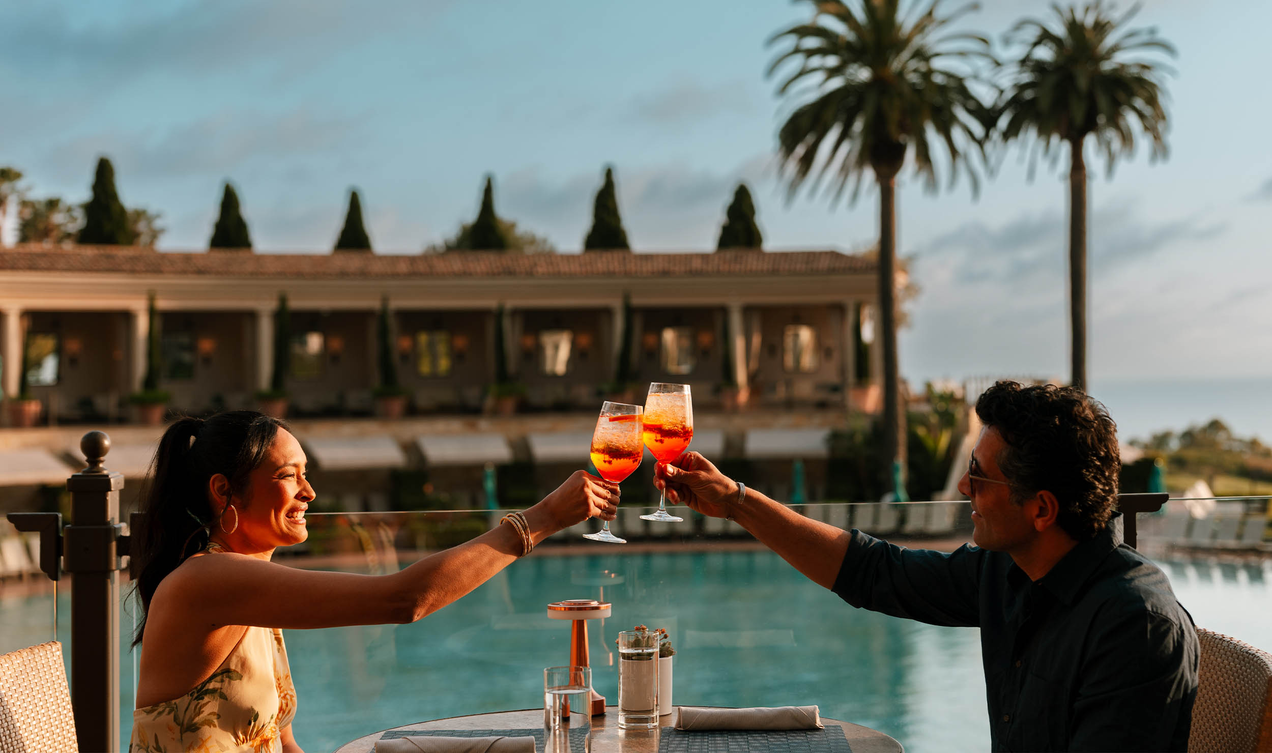 couple cheers at coliseum pool restaurant